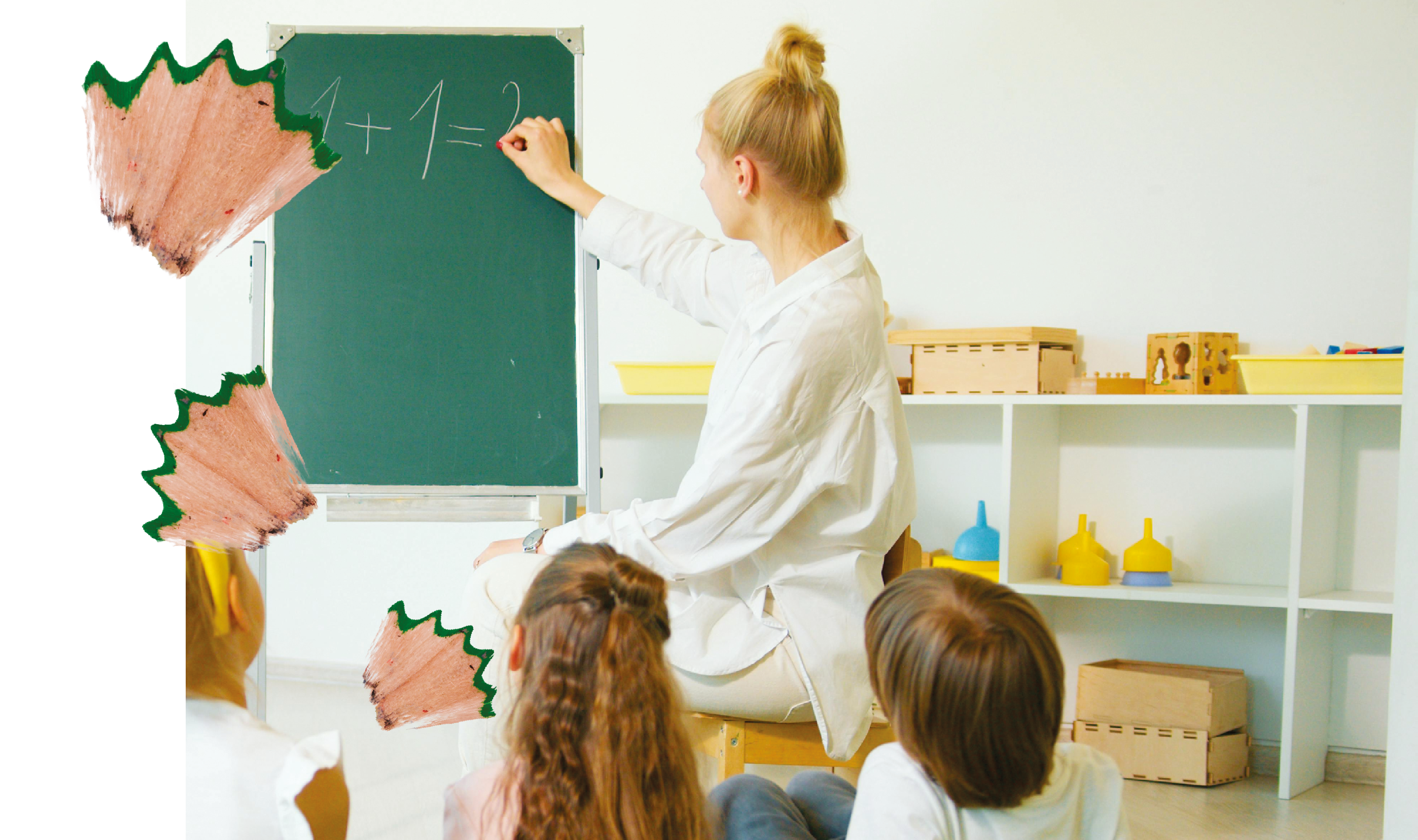 Eine Lehrerin schreibt an eine Tafel „1 + 1 =“, während mehrere Kinder vor ihr sitzen und zuschauen, umgeben von dekorativen Bleistiftspänen.